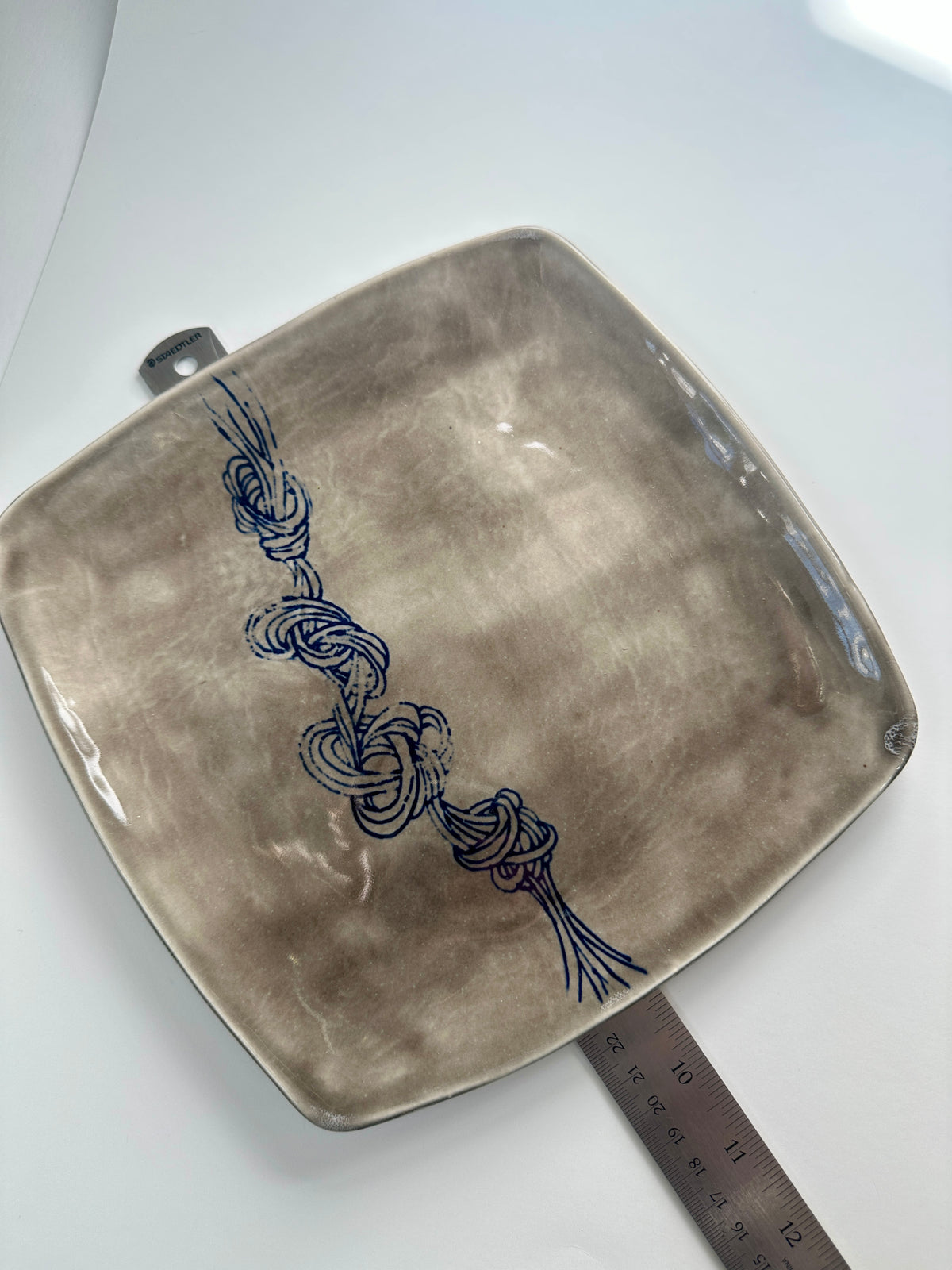 Grey square knot plate